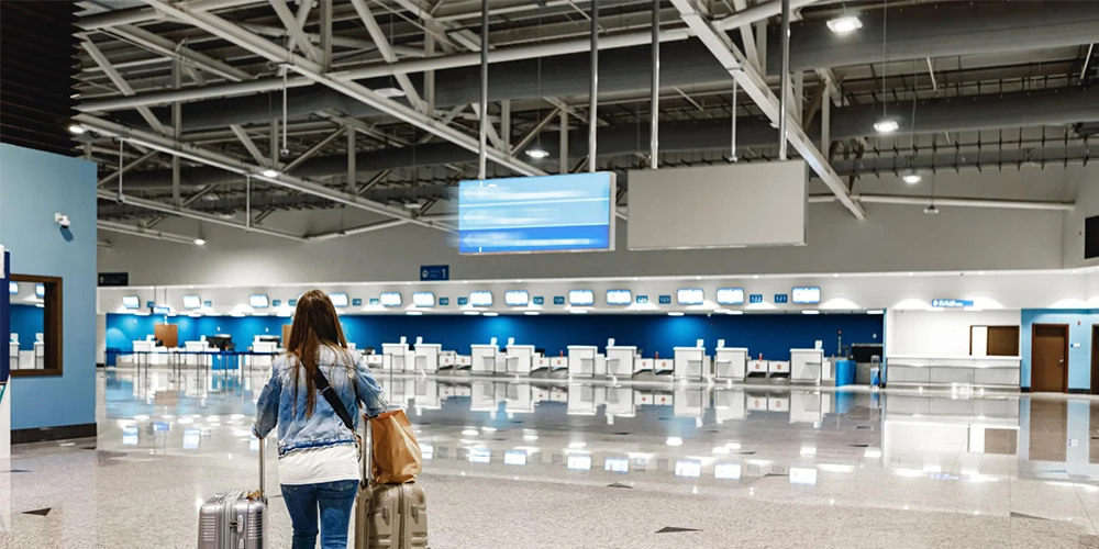 a women walking a airport terminal