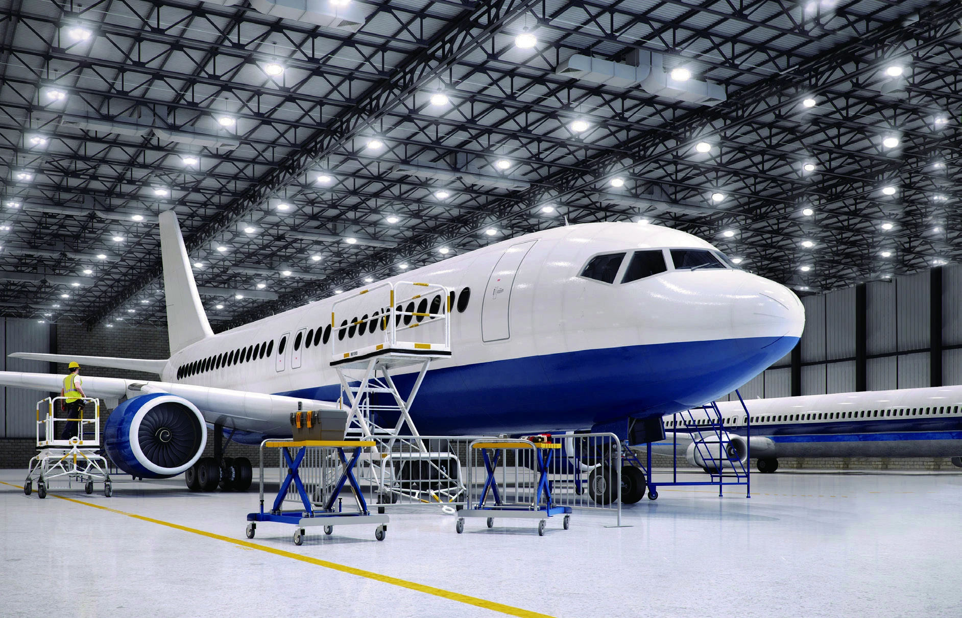 Aircraft maintenance hangar illuminated by high bay luminaires